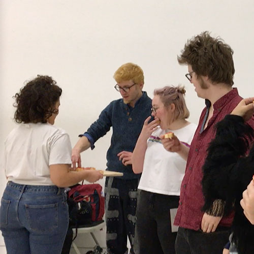 Performer Yifat Shir-Moskovitz is handing out pieces of bread with jam, before the audience sees how the jam is made